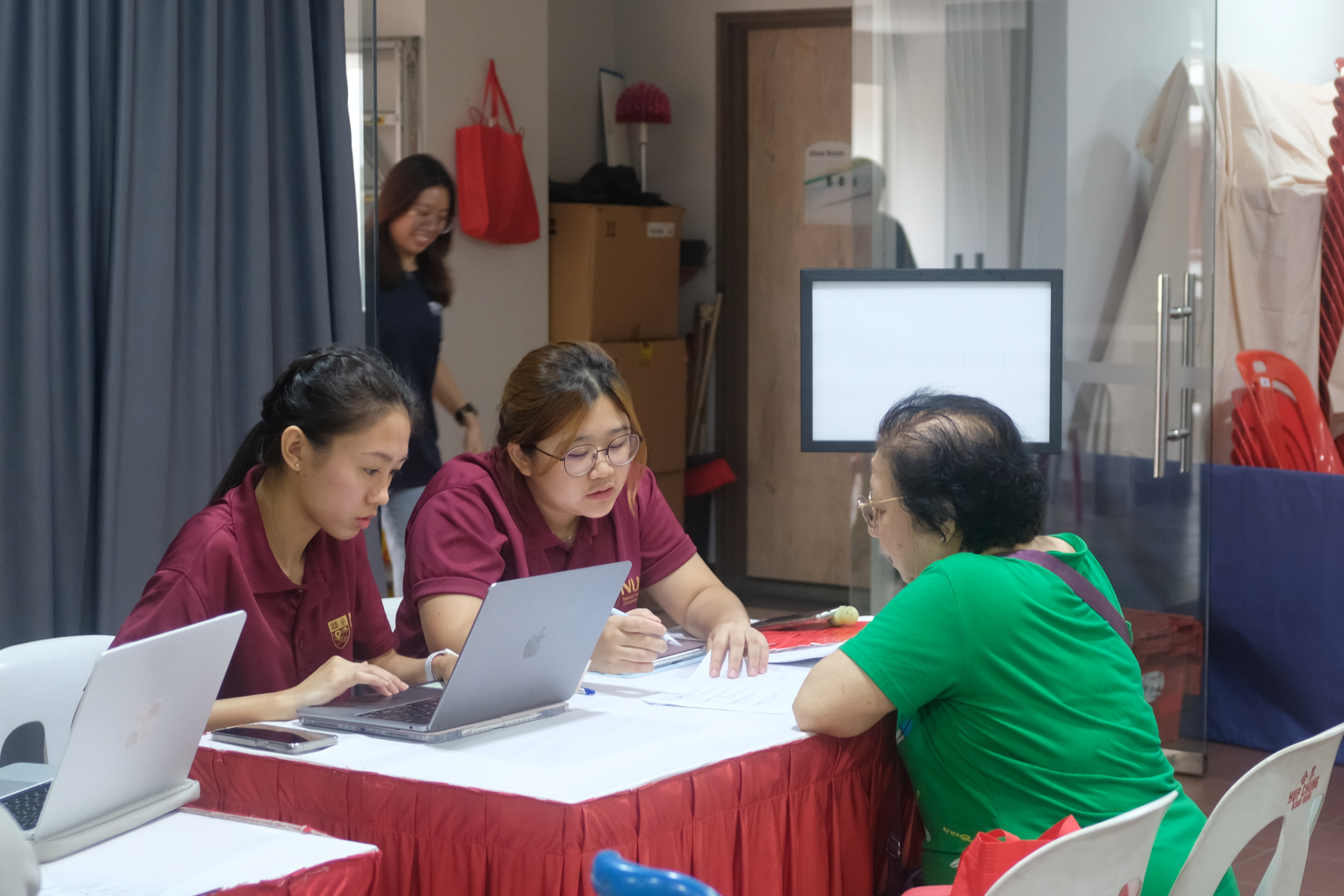 Two students consulting with resident